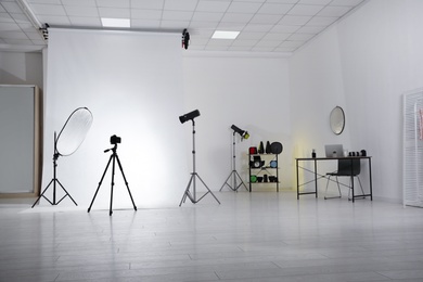 Photo of Photo studio interior with set of professional equipment and workplace