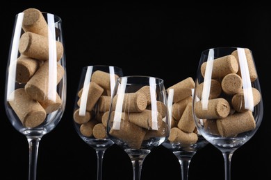 Photo of Glasses full of many wine corks on black background