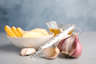 Composition with garlic and other cold remedies on grey table