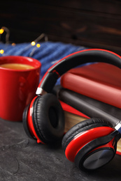 Books, coffee and headphones on grey table