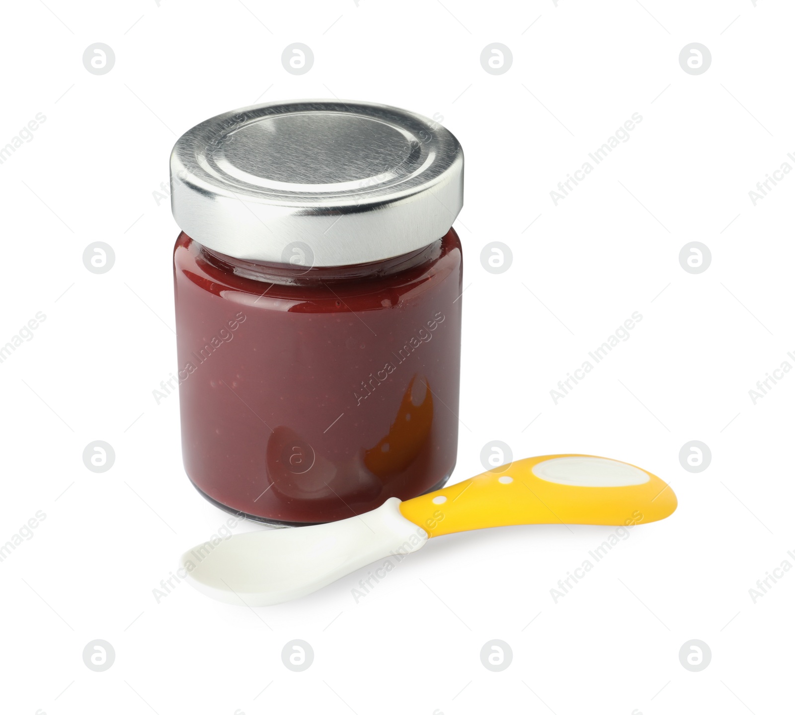 Photo of Jar of healthy baby food and spoon on white background
