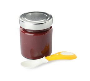 Photo of Jar of healthy baby food and spoon on white background