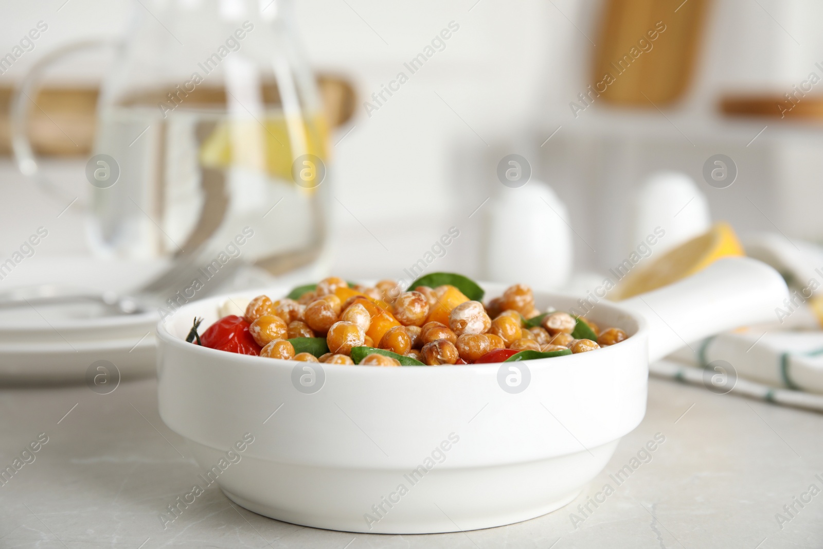 Photo of Delicious fresh chickpea salad on light grey marble table