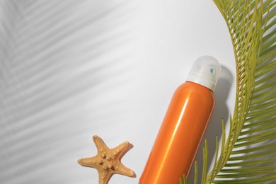 Sunscreen, starfish and tropical leaf on white background, flat lay and space for text. Sun protection care