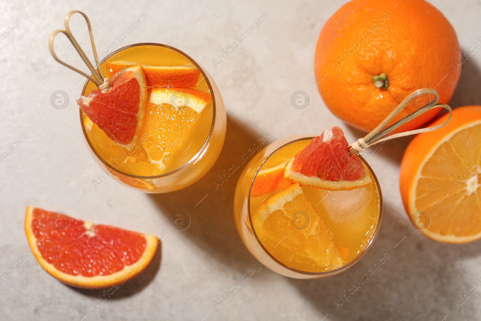 Photo of Delicious orange soda water on light table, flat lay