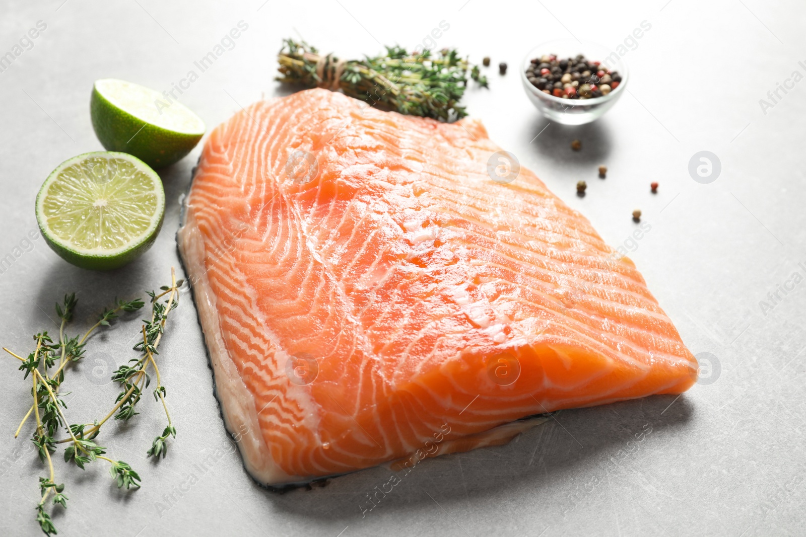 Photo of Raw salmon fillet and ingredients for marinade on table