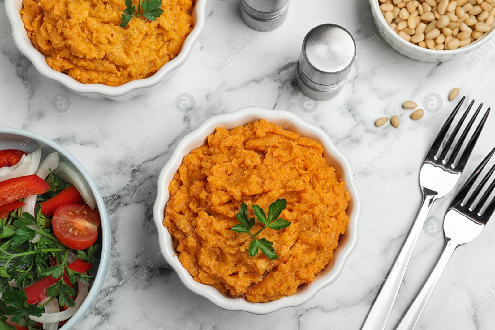 Photo of Flat lay composition with bowl of sweet potato puree on marble table