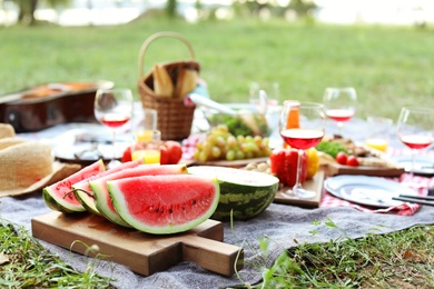 Photo of Blanket with food prepared for summer picnic outdoors