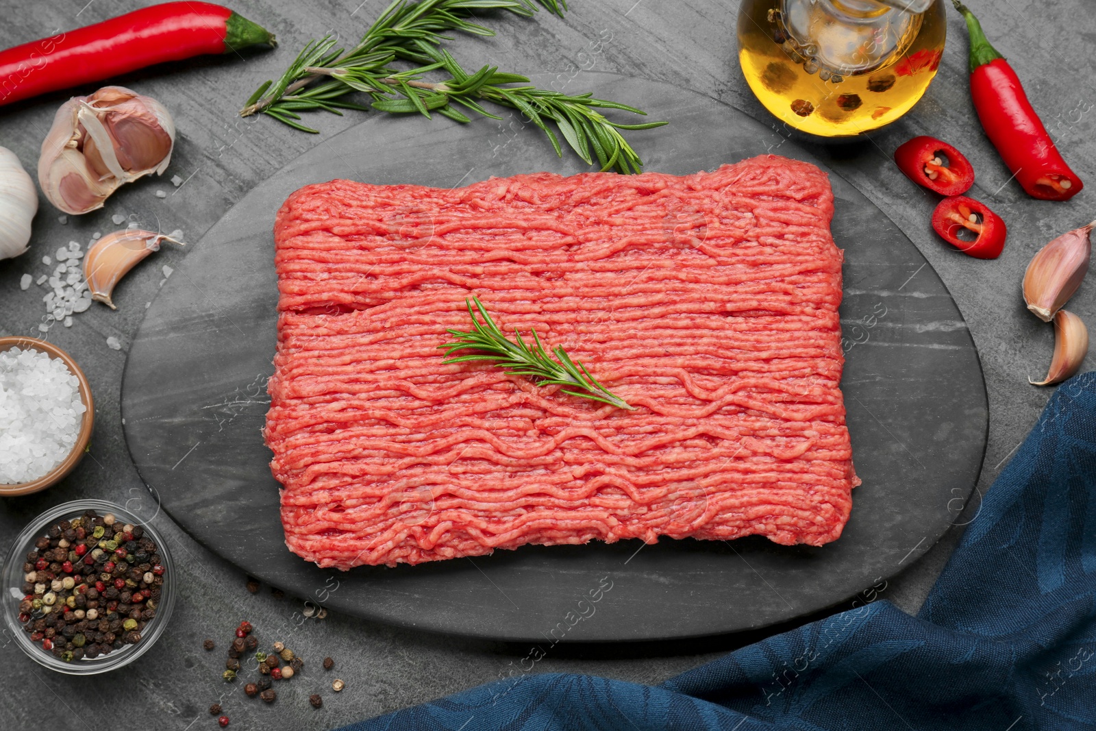 Photo of Raw fresh minced meat and ingredients on black wooden table, flat lay