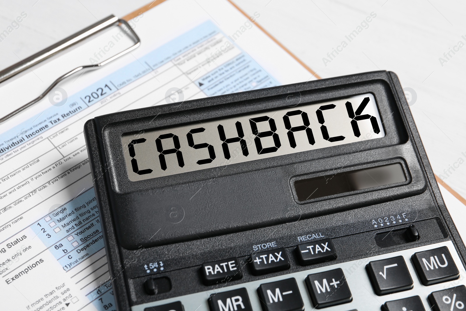 Image of Calculator with word Cashback on documents, closeup