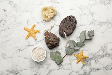 Flat lay composition with pumice stones on white marble background