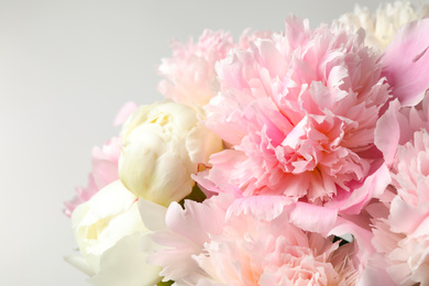 Photo of Beautiful peony bouquet on light background, closeup