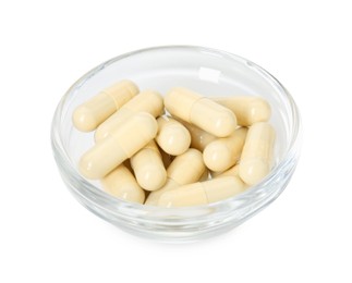 Vitamin capsules in bowl isolated on white. Health supplement