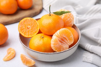 Photo of Fresh juicy tangerines on light grey table