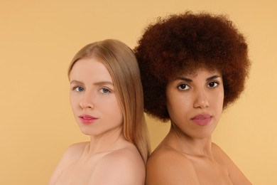 Portrait of beautiful young women on beige background