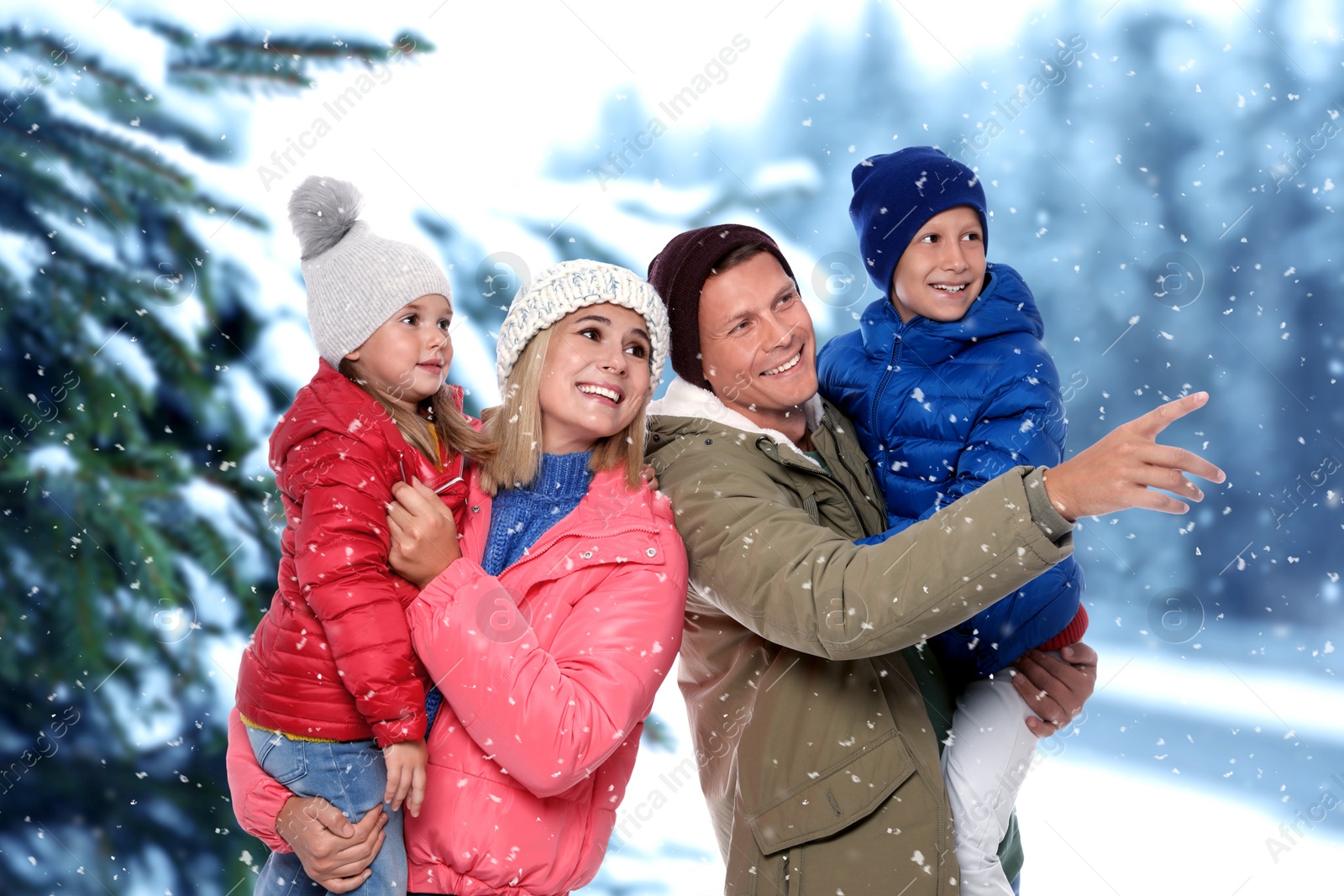 Image of Happy family spending time together near winter forest
