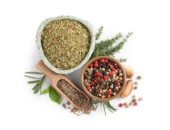 Different natural spices and herbs on white background, top view