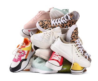 Photo of Pile of different female sneakers isolated on white