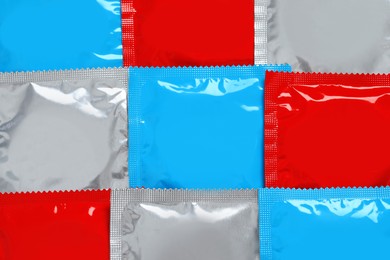 Condom packages as background, top view. Safe sex