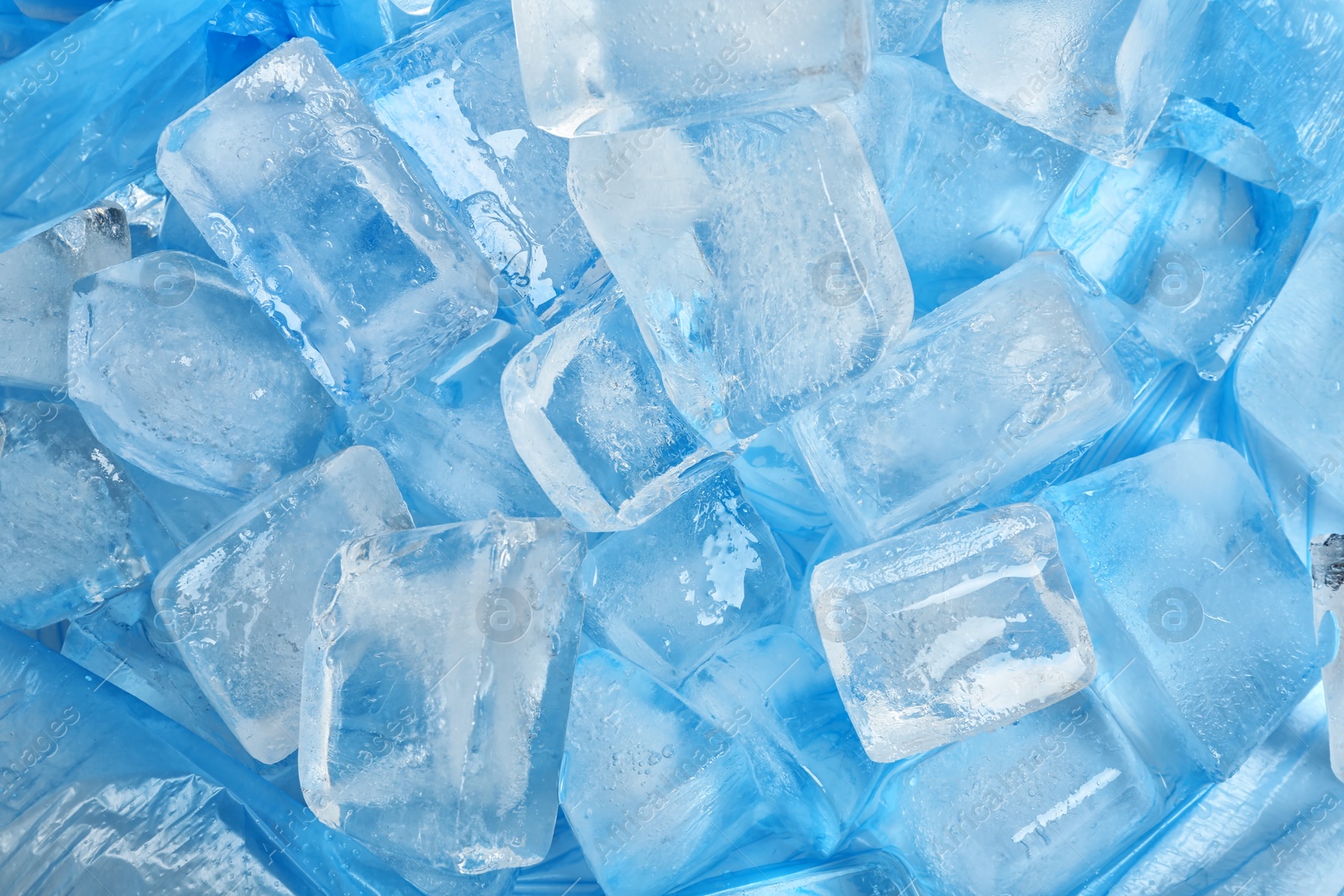 Photo of Many ice cubes on color background, top view