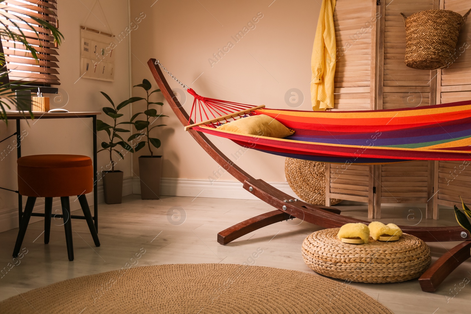 Photo of Colorful hammock with pillow in modern room interior