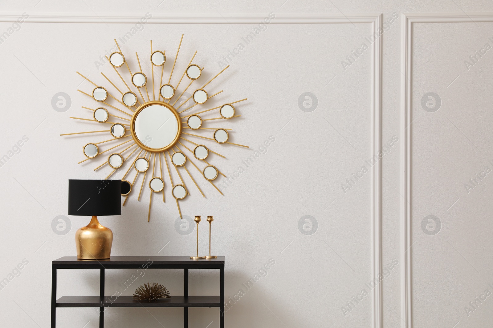 Photo of Console table near white wall with mirror in hallway, space for text. Interior design