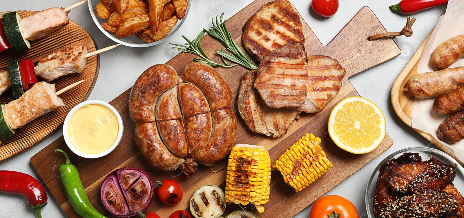 Image of Flat lay composition with barbecued meat and vegetables on light table. Banner design