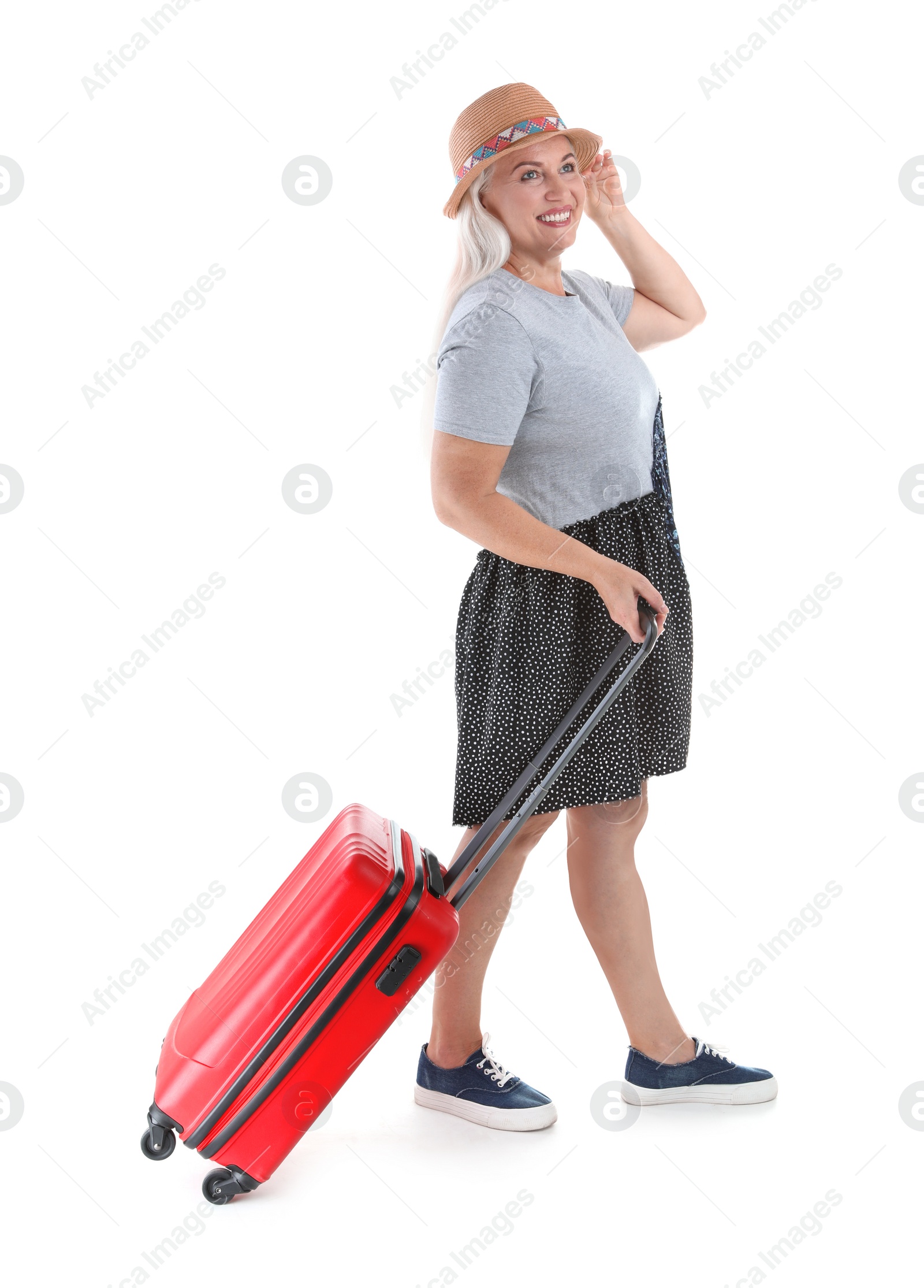 Photo of Senior woman with suitcase on white background. Vacation travel