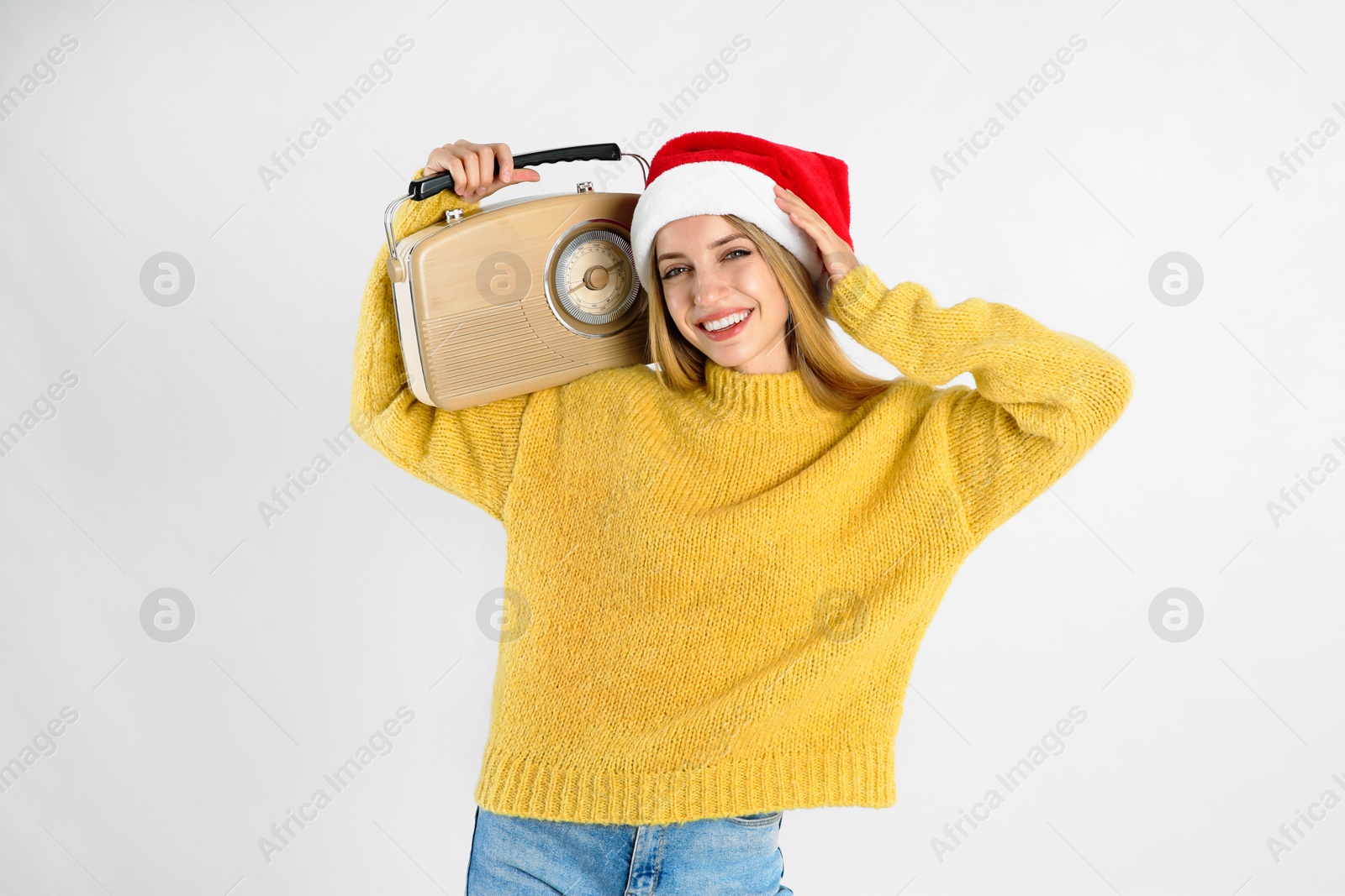 Photo of Happy woman with vintage radio on white background. Christmas music