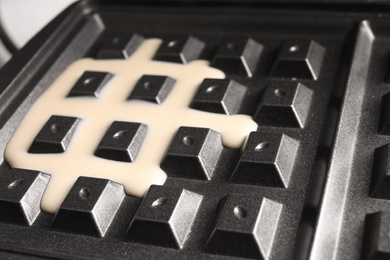 Photo of Modern Belgian waffle maker with dough, closeup