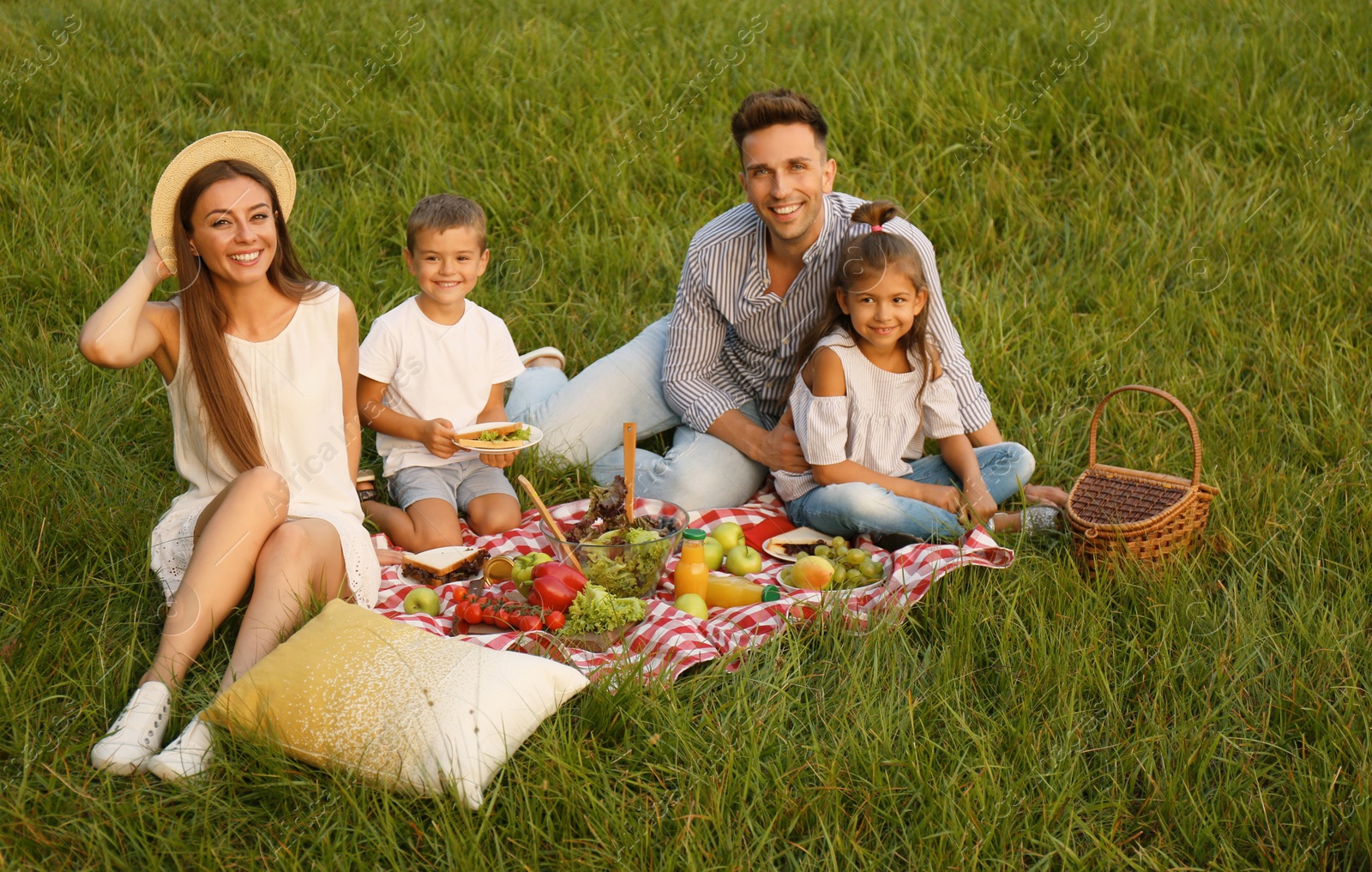 Photo of Happy family having picnic in park on summer day