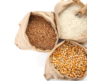 Photo of Paper bags with different types of grains and cereals on white background