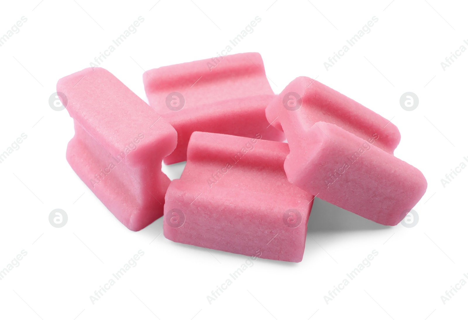 Photo of Many tasty pink chewing gums on white background