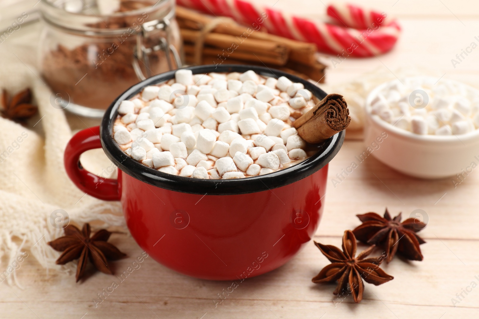 Photo of Tasty hot chocolate with marshmallows on white wooden table, closeup