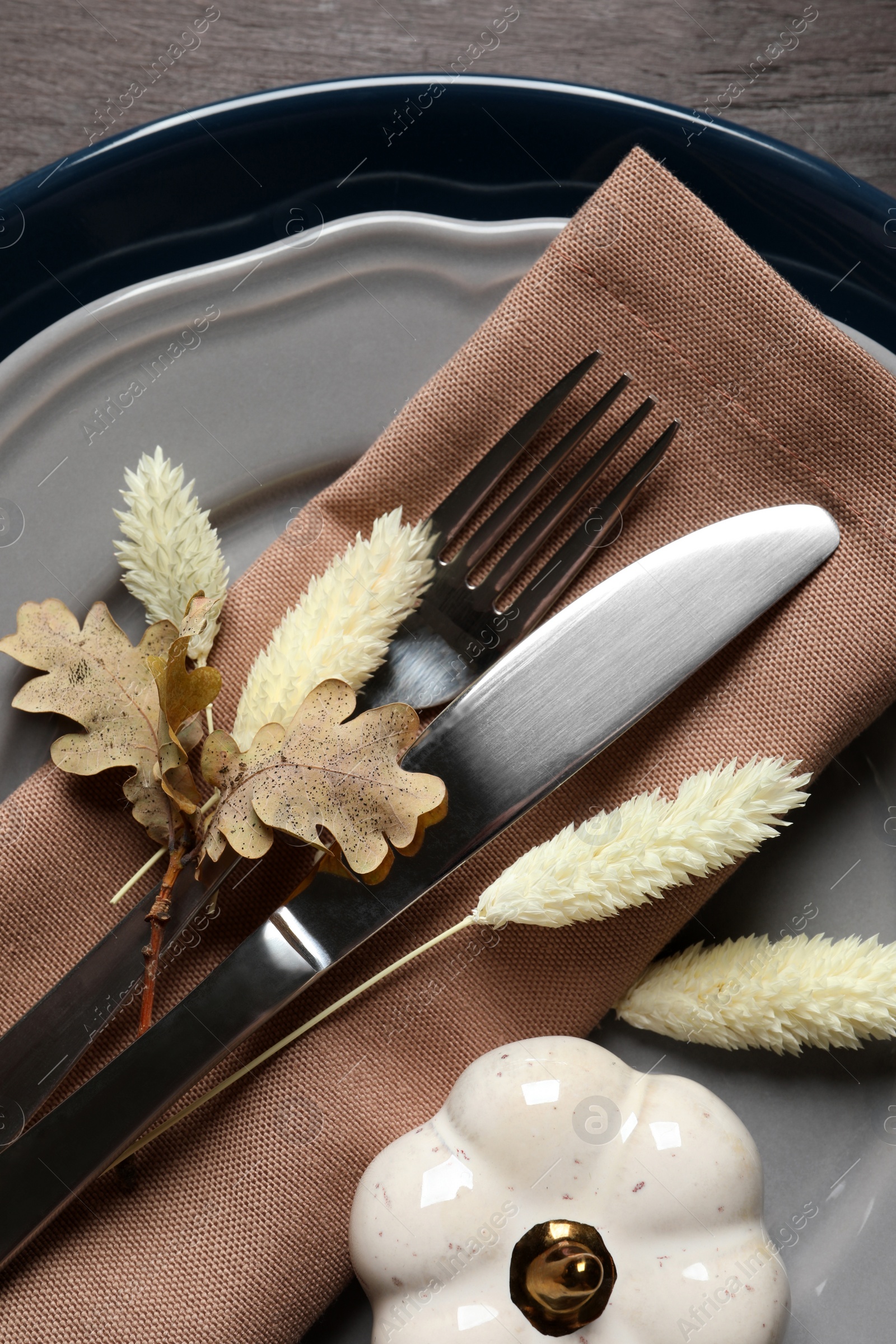 Photo of Autumn table setting on wooden background, top view