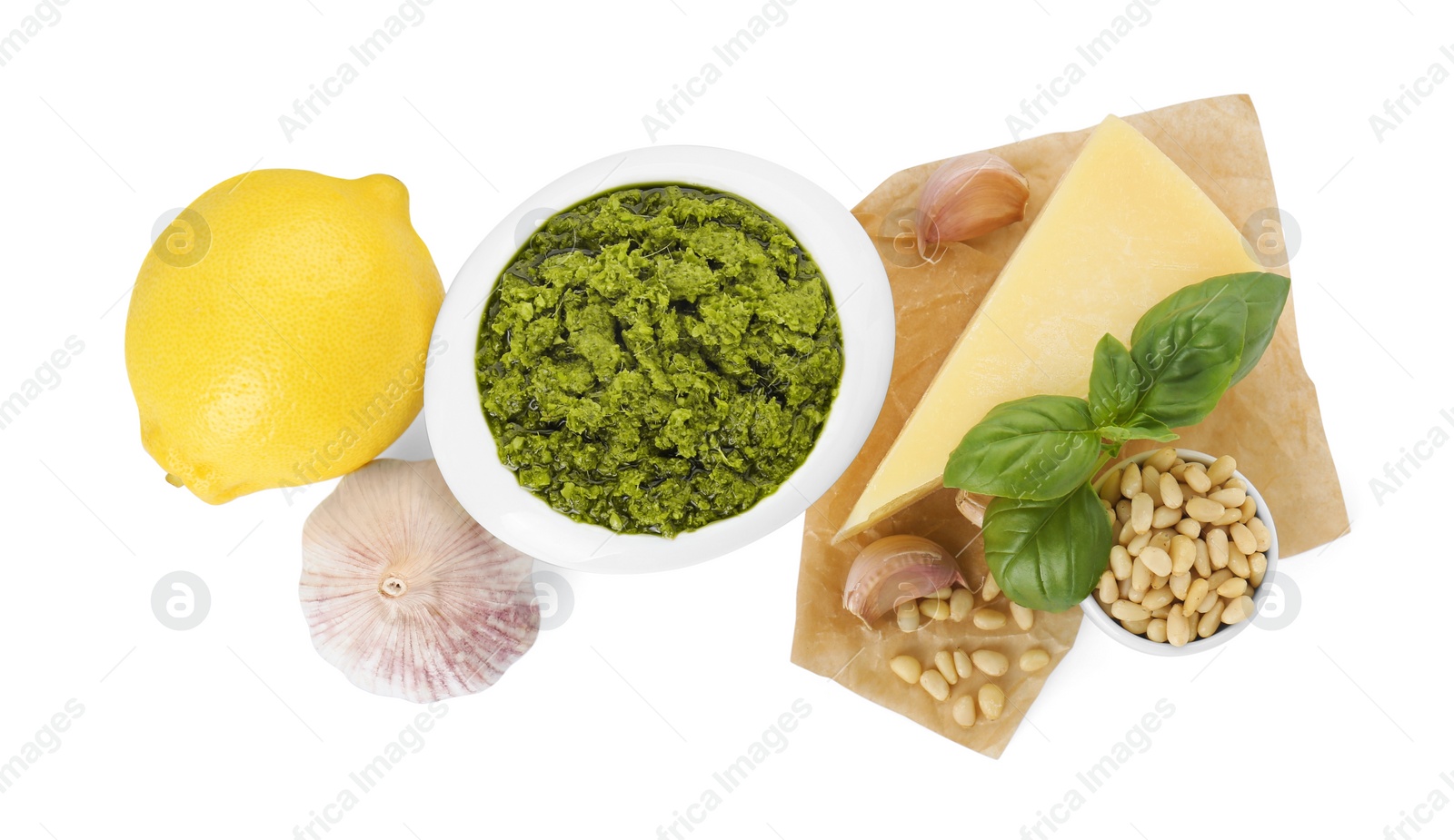 Photo of Delicious pesto sauce in bowl and ingredients isolated on white, top view