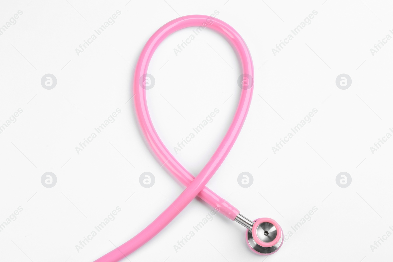 Photo of Pink stethoscope isolated on white, top view. Breast cancer awareness