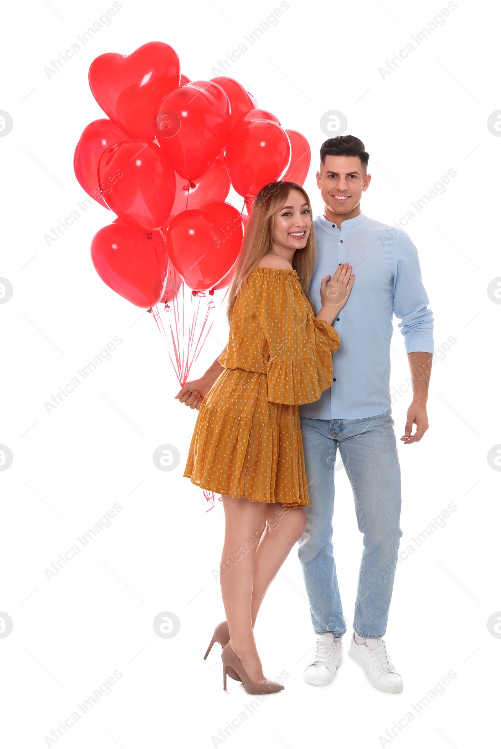 Photo of Lovely couple with heart shaped balloons on white background. Valentine's day celebration