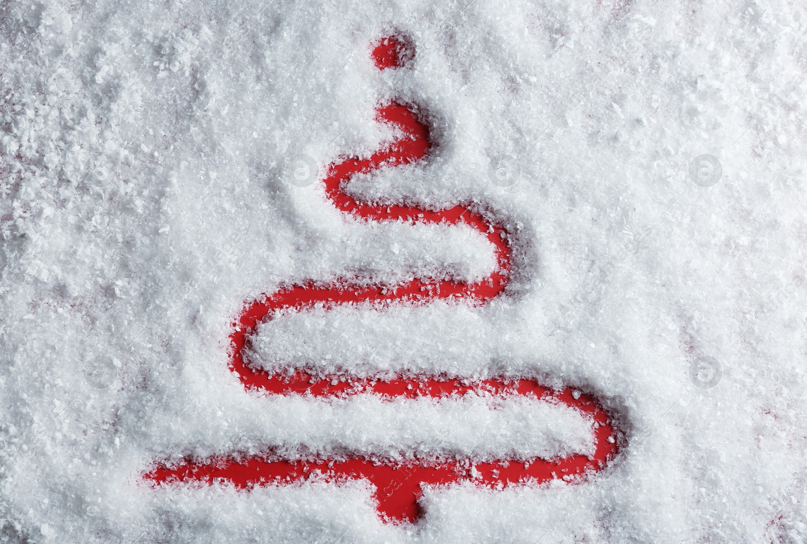 Photo of Christmas tree silhouette in snow on color background, top view