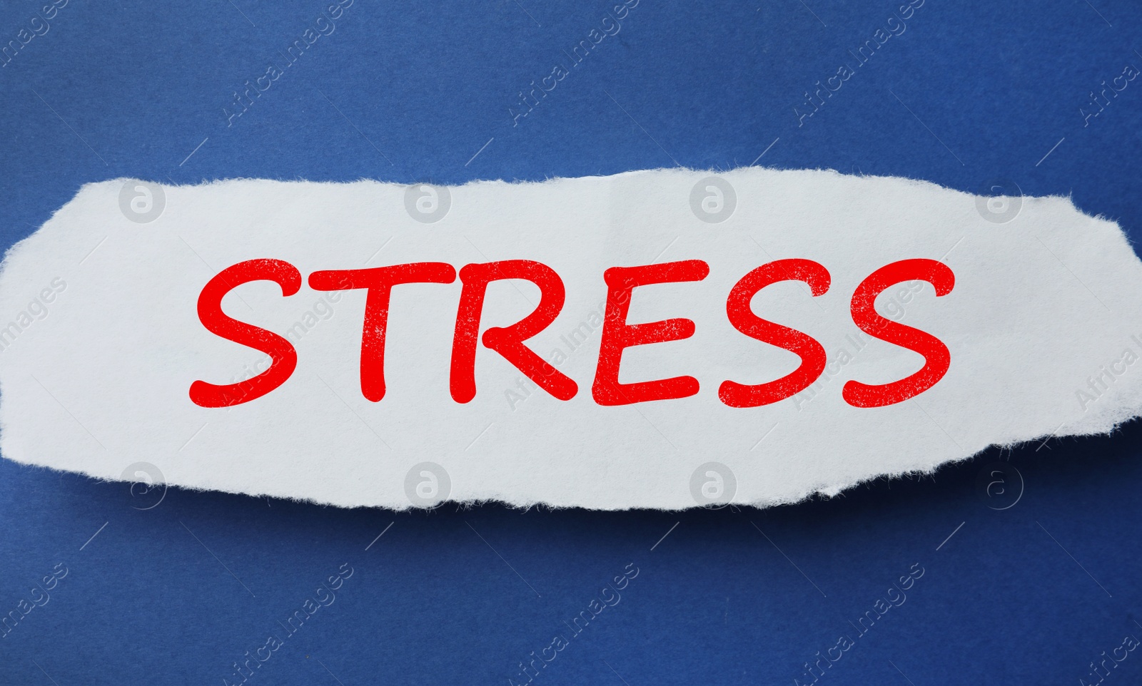 Photo of Piece of paper with word Stress on blue background, top view