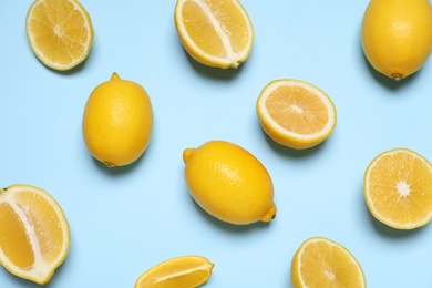 Photo of Many fresh ripe lemons on light blue background, flat lay