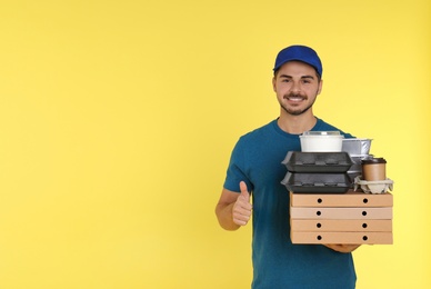 Photo of Young courier with different orders on color background, space for text. Food delivery service