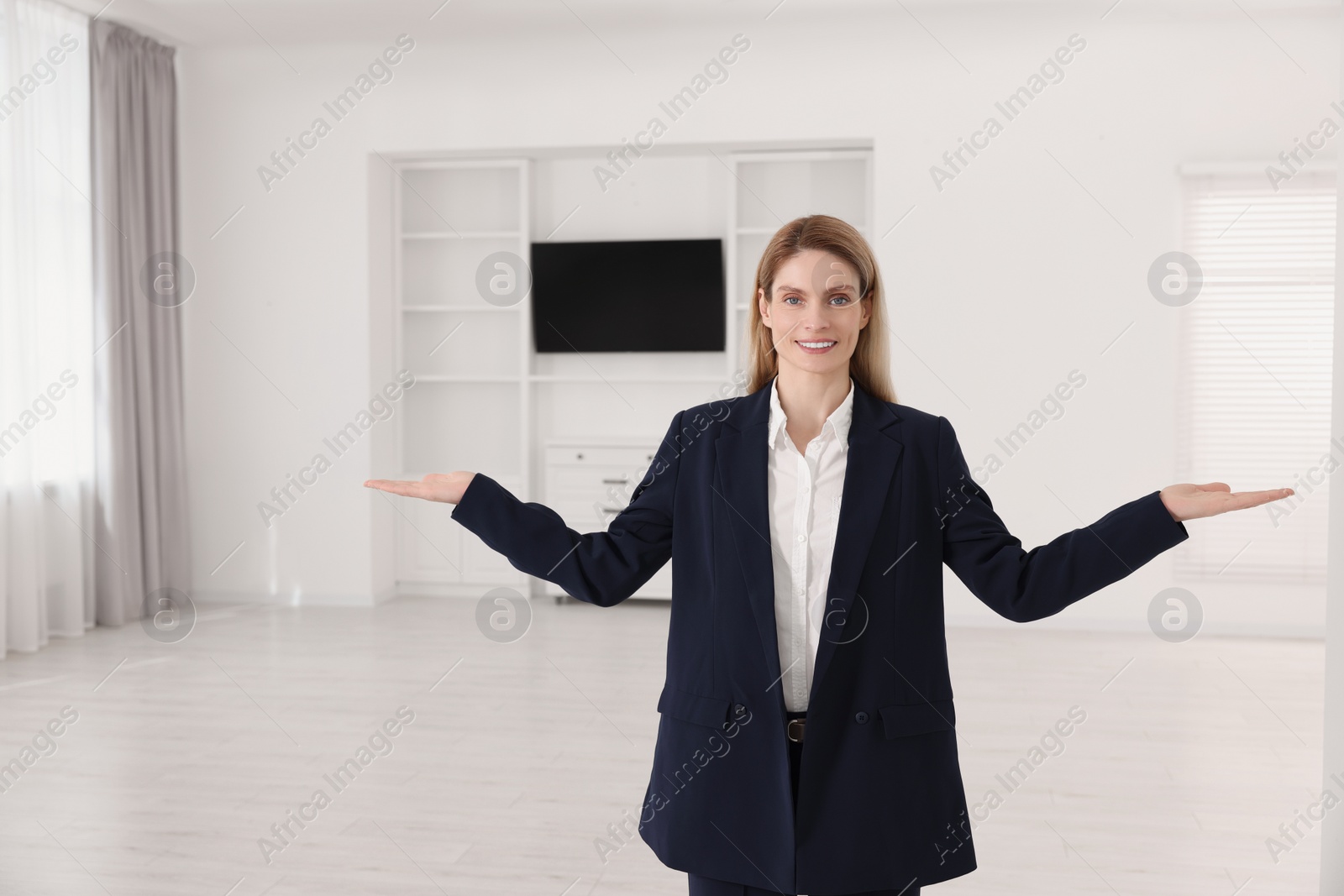 Photo of Happy real estate agent showing new apartment