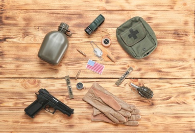 Set of military equipment on wooden background, flat lay