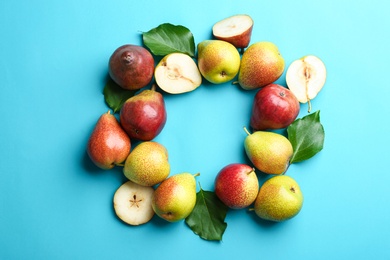 Ripe juicy pears on blue background, flat lay. Space for text