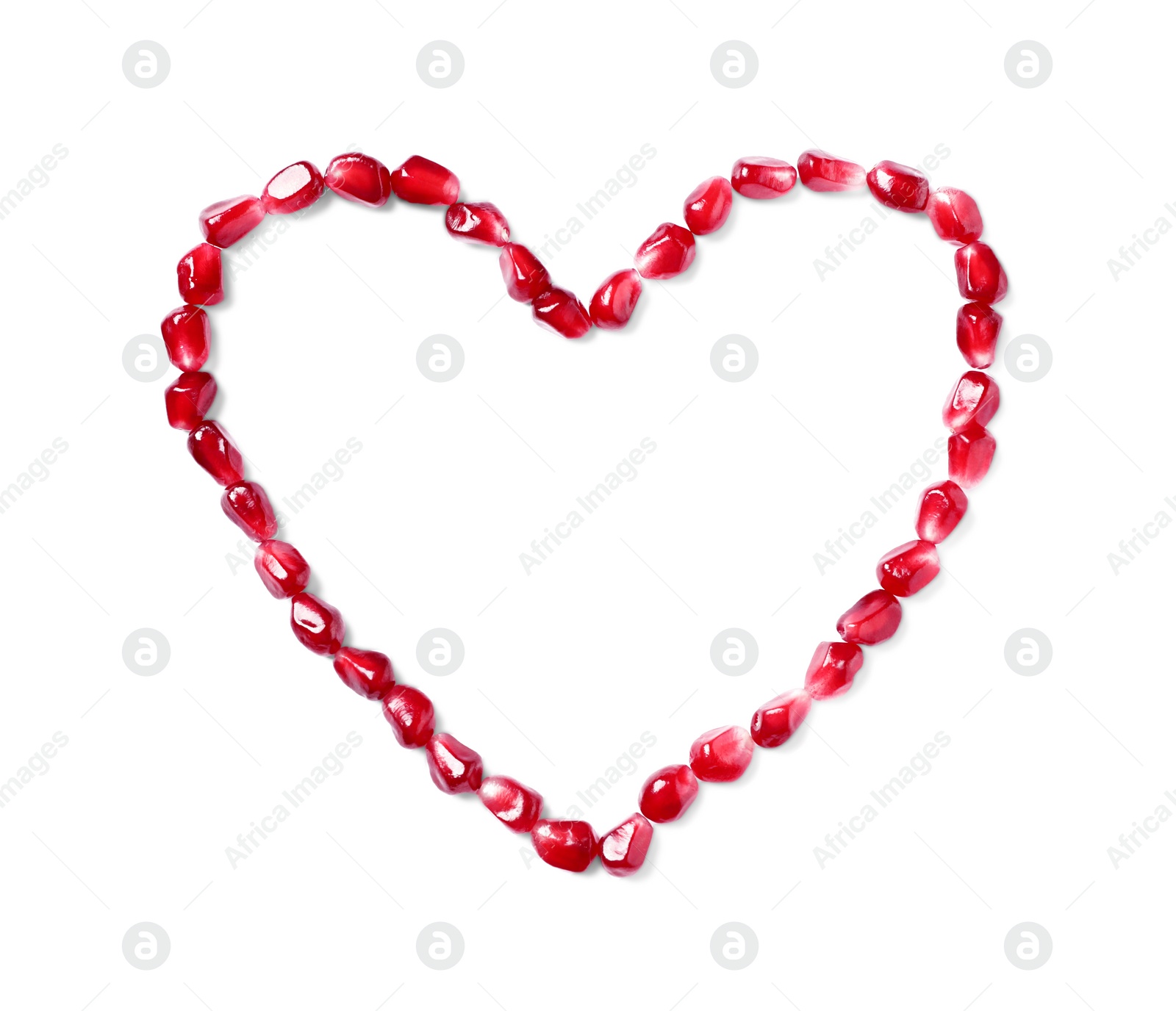 Photo of Heart made of tasty pomegranate seeds on white background, top view