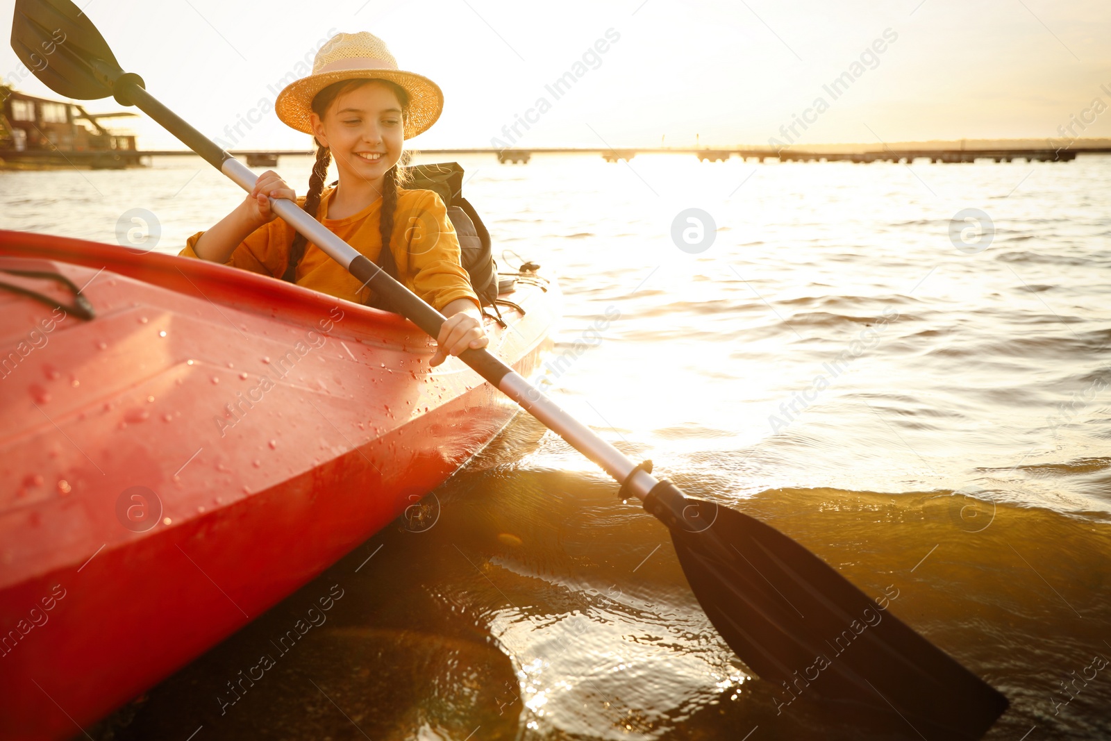 Photo of Happy girl kayaking on river. Summer camp activity