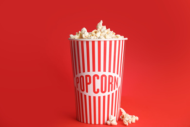 Tasty fresh pop corn on red background