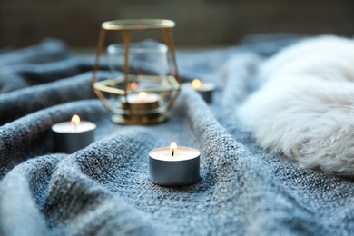 Beautiful burning candles on fabric. Time to relax