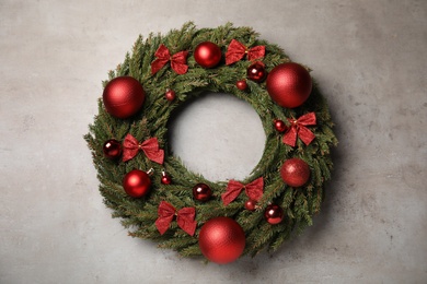 Photo of Beautiful Christmas wreath on grey background, top view